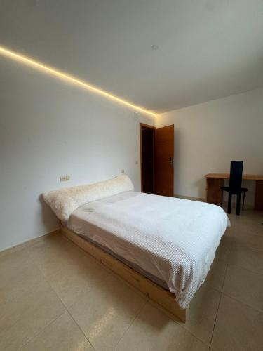a bedroom with a bed with a light on the wall at Hilda's Queen Room private bathroom in Roses