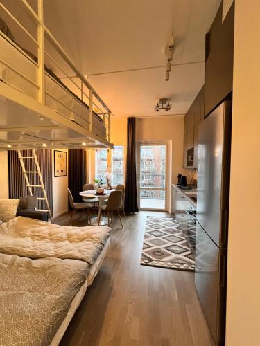 a bedroom with a bed and a dining room at Nordic NOVA Studio in Stockholm