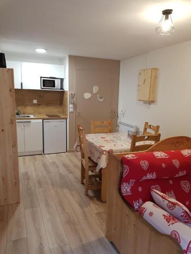 a kitchen and a dining room with a table in a room at Abondance studio la marmotte in Abondance