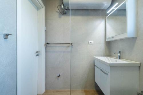 a bathroom with a shower and a sink at Blue Eye Apartment in Sarandë