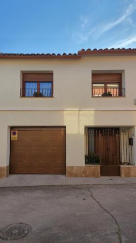 a house with two garage doors and two windows at En Ca La Abuela Casa Rural in Consuegra
