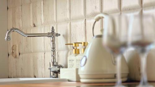 a kitchen sink with a faucet and a bottle of soap at Old Town Gdansk Olives Marina Apt 2 min walk to Motlawa River in Gdańsk