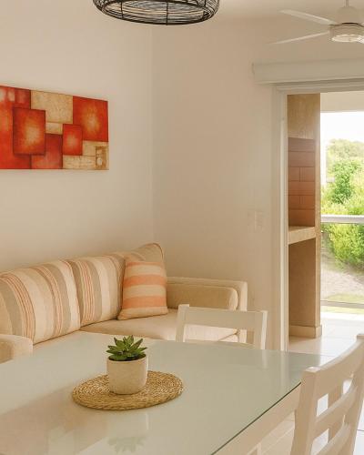 a living room with a couch and a table at Terraza Marina V in Pinamar