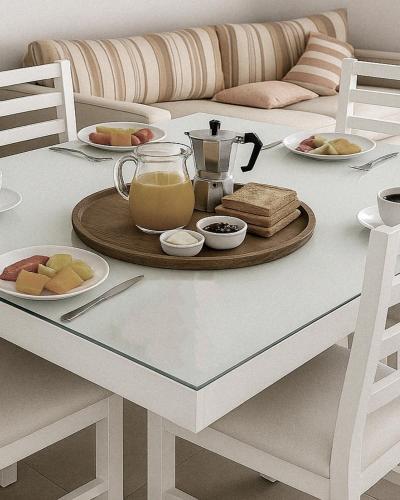 a white table with a tray of food on it at Terraza Marina V in Pinamar