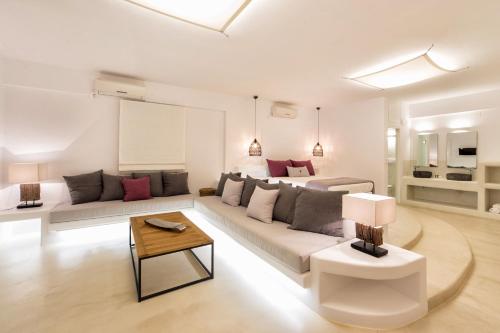 a living room with a couch and a table at Anna Platanou Suites in Agia Irini Paros