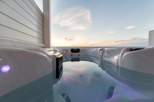 a bathtub with a fish in it in front of a window at Anna Platanou Suites in Agia Irini Paros