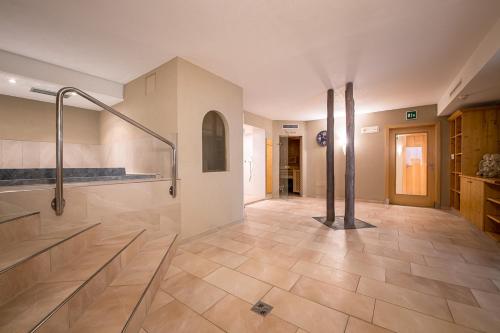 a large bathroom with a shower and a sink at Hotel Waldheim in Valle Di Casies