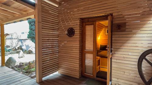 a wooden room with an open door to a sauna at Camping-Fass inklusive Sauna & Frühstück, Bad & WC über die Terrasse in Halle an der Saale