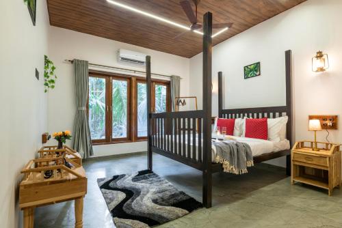 a bedroom with a crib in a room at Cabanas Retreat in Revadanda