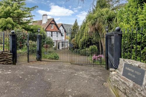 a gate to a house with a sign in front of it at Bay View Porlock Bed & Breakfast in Porlock