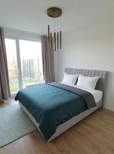 a bedroom with a bed and a large window at Garden Residence in Nitra