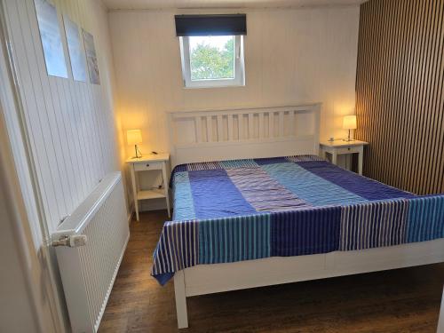 a bedroom with a bed and two night stands at Sandra Fewo nähe Rømø in Bredebro in Bredebro