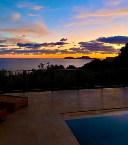 a sunset view of the ocean from a patio at Petres Luxury Villas with heated private pool in Agia Galini