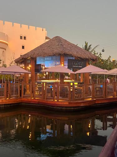 a restaurant with tables and umbrellas next to the water at Gran Luxxe 2 bdrm suite in Nuevo Nayarit