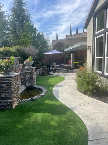a garden with green grass and a walkway at Gran Luxxe 2 bdrm suite in Nuevo Nayarit