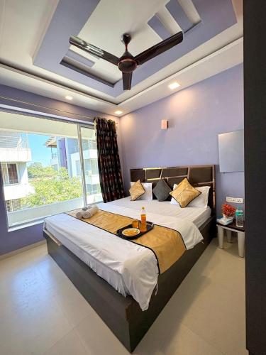 a bedroom with a large bed and a large window at SilverOak 4bhk Villa in Jāmb