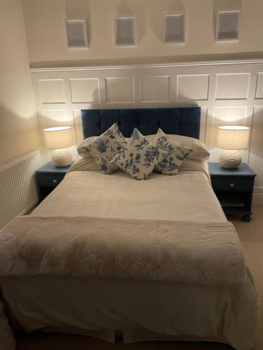 a bed with two lamps and two pillows on it at By the Sea in Redcar