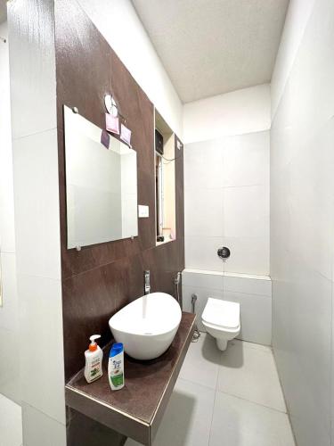 a bathroom with a sink and a toilet at SilverOak 4bhk Villa in Jāmb