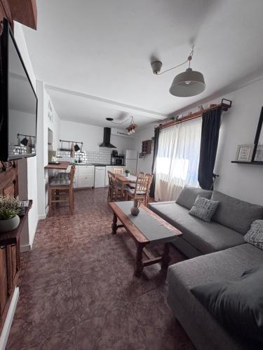 a living room with a couch and a table at El Capricho de Nunu SIMANCAS in Simancas