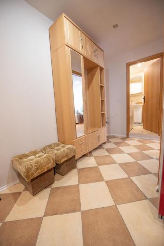 a room with a cabinet and a checkered floor at Patricia Apartments in Vilnius