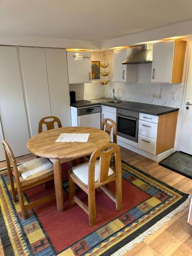 a small kitchen with a wooden table and chairs at Ferienwohnung Im Einklang in Buchen