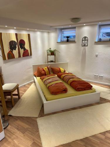 a white bed in a room with a white wall at Ferienwohnung Im Einklang in Buchen