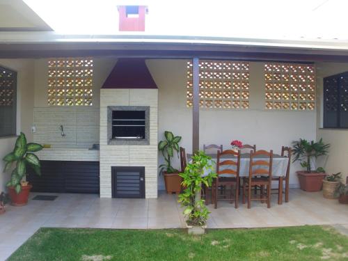 a patio with a table and chairs on it at Residencial Susy in Bombinhas