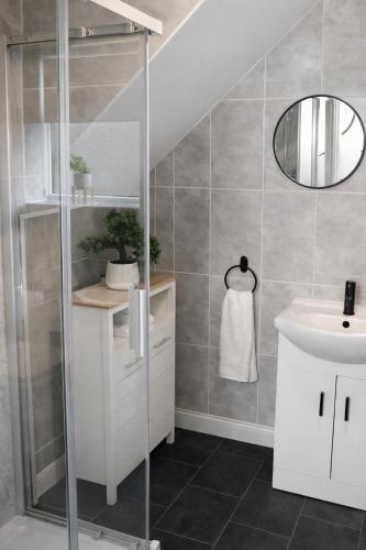 a bathroom with a glass shower and a sink at That's Amore House 3 bedroom house with parking walking distance to Sandbach town in Sandbach