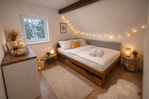 a bedroom with a bed with lights on it at Chaloupka v ráji in Veselá