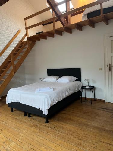 a bedroom with a bed and a wooden floor at Brussels EU District Mansion in Brussels