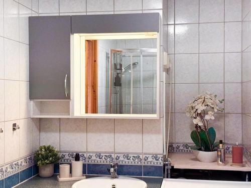 a bathroom with a sink and a mirror at Nordic Comfort Apartment in Trondheim
