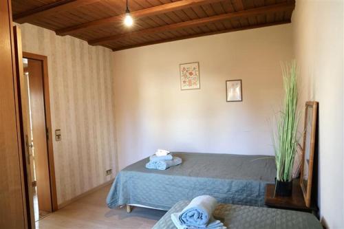 a bedroom with a bed with a blue blanket at Zurück zur Wurzel in Karsau
