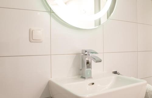 a white bathroom with a sink and a mirror at Alpenresorts in Jerzens