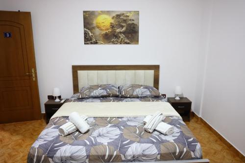a bedroom with a bed with two phones on it at Guesthouse Alemannia in Berat