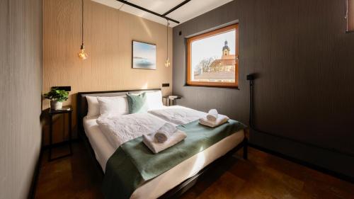 a bedroom with a bed with towels on it at Stadthaus Neckarsulm serviced apartments - Stadthaus Heiner in Neckarsulm