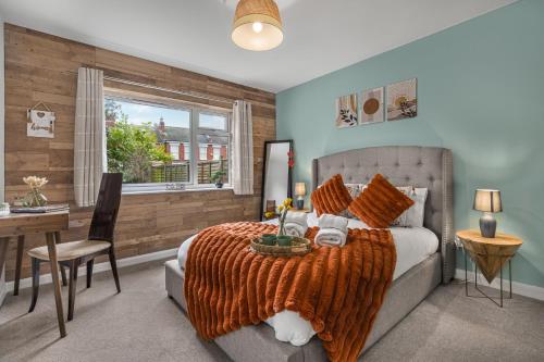 a bedroom with a bed and a desk and a window at 2BR Apartment Free Parking Sleeps 4 Cheltenham in Cheltenham