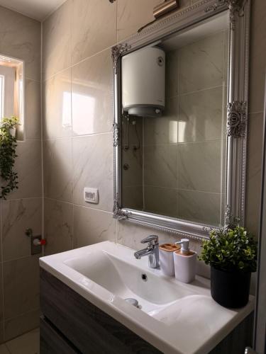 a bathroom with a sink and a mirror at Apartments Pablo Novalja in Novalja
