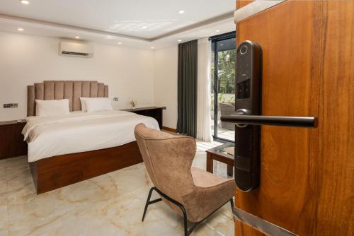 a bedroom with a bed and a chair in a room at Lasantha's Residence in Kadawata