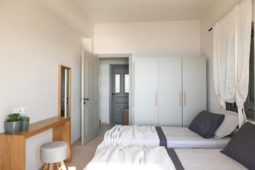 a bedroom with a bed and a white cabinet at Villa Pothaia in Myrties