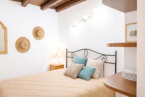 a bedroom with a bed with blue and white pillows at Damiani Case Vacanze Palermo - Centro Storico in Palermo