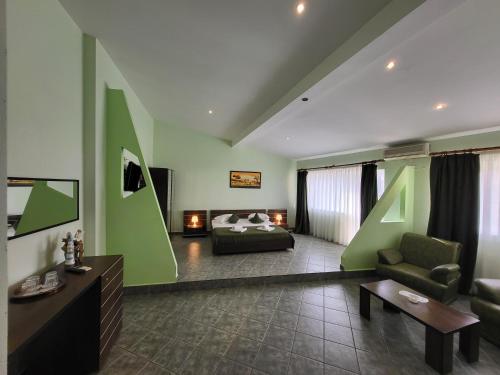 a large living room with a bed and a couch at Vila Casa Esy in Eforie Nord