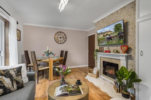 a living room with a couch and a fireplace at 2BR Apartment Free Parking Sleeps 4 Cheltenham in Cheltenham