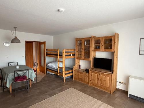 a living room with a bunk bed and a television at Ferienwohnung Voges in Bad Lauterberg