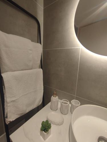 a bathroom with a white sink and a mirror at Ventalia in Kimolos