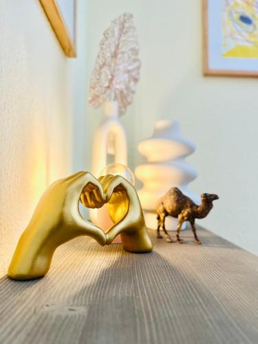 a pair of goldoons forming a heart with a goat in the background at KÜCHWALDBLICK Designsuite in Chemnitz