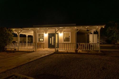 a house with a porch at night with lights at Nos Casita - 5 min walk to the beach in Pos Chiquito