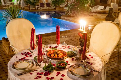 a table with a plate of food on top of it at Riad Dar Sofian in Zagora