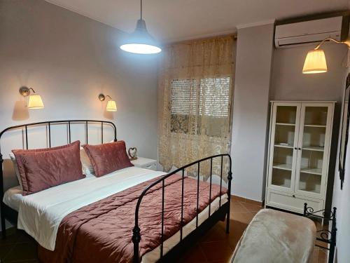 a bedroom with a bed with red pillows and a window at Sunny And Waves Apartment in Golem