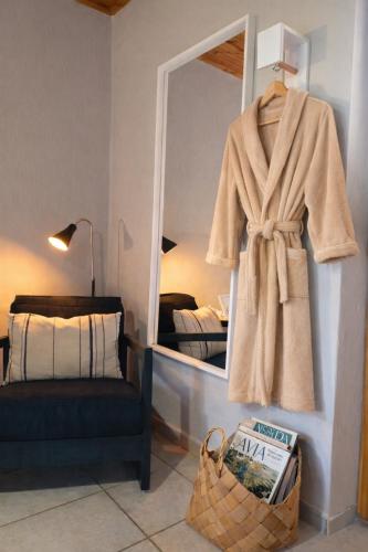a robe hanging on a mirror in a room at Nafplio Cottage-Grandma's Yard in Asíni