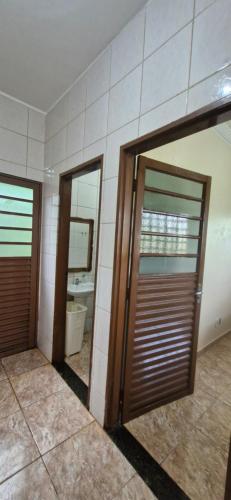 a bathroom with two doors and a mirror at Canto dos Pássaros in Brasília
